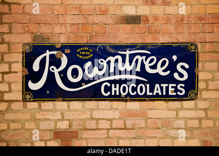 Close up of vintage old authentic Rowntree Rowntree's chocolates advertisement metal tin sign on a wall England UK United Kingdom GB Great Britain Stock Photo