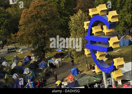 Tents are set up next to the euro symbol in front of the European Central Bank (ECB) in Frankfurt am Main, Germany, 25 October 2011. The capitalism-criticizing 'Occupy Frankfurt' movement endures the autumn temperatures and remains put in front of the bank. According to movement members, the inhabitants of the 70 to 80 tents plan to yet again march through Frankfurt's inner-city on Stock Photo