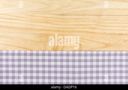 Purple checkered table cloth on a wooden background Stock Photo