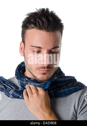 Young man with scarf, holding his neck because of throat ache with suffering expression Stock Photo