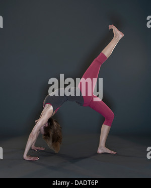 Studio shot of mid adult woman practicing yoga Stock Photo