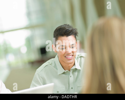 Young man studying and smiling Stock Photo