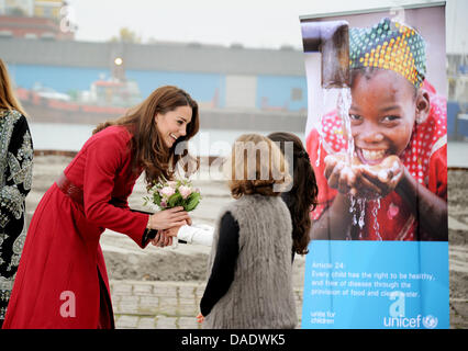 The Duchess of Cambridge (L) receives flowers from two local girls upon her arrival at UNICEF's Supply Division in Copenhagen, Denmark, 2 November 2011. The Duke and Duchess of Cambridge (William and Catherine) accompanied by the Crown Prince and Crown Princess of Denmark (Frederik and Mary) made a special visit to the UNICEF global supply centre in Copenhagen to raise awareness fo Stock Photo