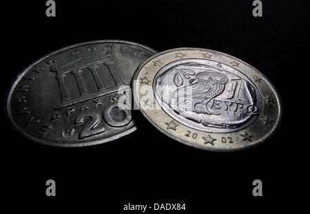 File - Illustration - An archive picture dated 03 May 2010 shows a Greek Euro coin and a Greek 20 Drachm coin. After the controversial announcement to hold a referendum in Greece and massive international critique, the internal political conflict escalates: The future of Greek Prime Minister George Papandreou's government was in doubt as lawmakers from his governing Socialist party Stock Photo