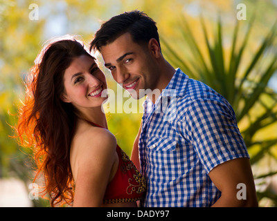 Young couple looking at camera, smiling Stock Photo