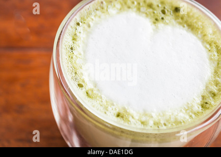 Hot matcha green tea latte in glass Stock Photo