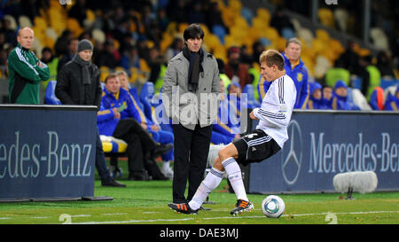 Germany's head coach Joachim Löw (C) watches Holger Badstuber controlling the ball during the friendly soccer match Ukraine vs Germany at Olimpiyskiy stadium in Kiev, Ukraine, 11 November 2011. Photo: Thomas Eisenhuth dpa Stock Photo