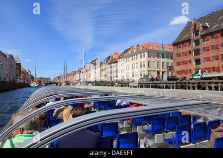 Tourists sightseeing on a canal tour boat in Nyhavn harbour, Copenhagen, Zealand, Denmark, Scandinavia Stock Photo
