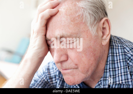 Senior man with head in hands Stock Photo