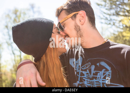 Couple kissing, woman wearing knit hat Stock Photo