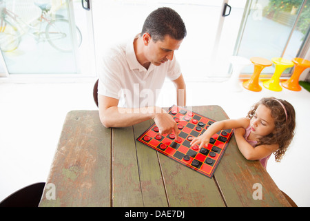 Father and daughter playing draughts Stock Photo