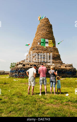Newtownabbey, Northern Ireland. 11th July 2013. People gather to see an enormous bonfire, estimated at over 30m (100ft), in Mossley. Credit:  Stephen Barnes/Alamy Live News Stock Photo
