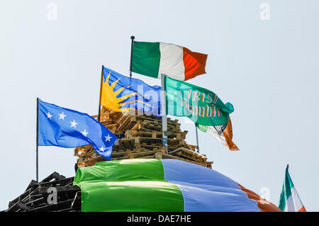 Newtownabbey, Northern Ireland. 11th July 2013. Irish flags on top of Ballyduff bonfire. Credit:  Stephen Barnes/Alamy Live News Stock Photo