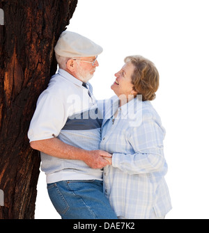 Affectionate Loving Senior Couple Leaning Against Tree Isolated on White. Stock Photo