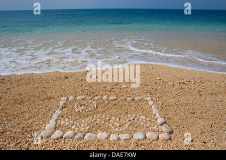 mosaik made of stones in the sand at the Mediterranean Sea showing the sun over sea waves, Italy, Sicilia Stock Photo