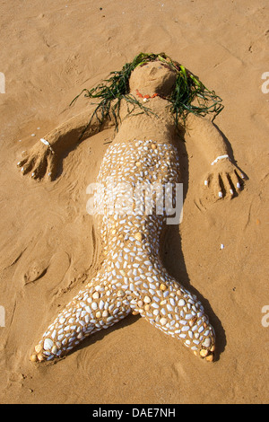mermaid created of Sand, seashells, little stones and algae at the mediterrian beach, Italy, Sicilia Stock Photo