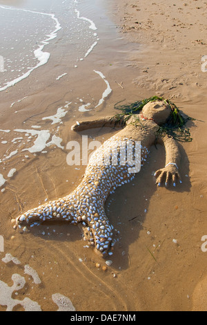 mermaid created of Sand, seashells, little stones and algae at the mediterrian beach, Italy, Sicilia Stock Photo