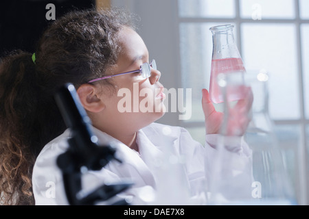 Girl holding conical flask Stock Photo