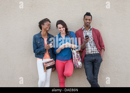 Three friends using cell phones Stock Photo