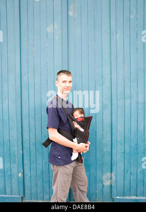 Father and baby boy in baby carrier Stock Photo