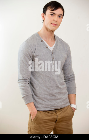 Portrait of young man wearing grey jumper Stock Photo