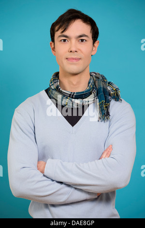 Portrait of young man wearing blue jumper and scarf Stock Photo