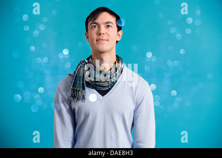 Portrait of young man wearing blue jumper and scarf Stock Photo