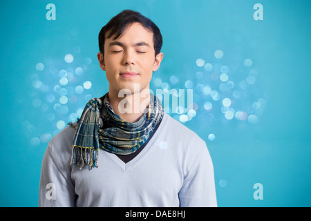 Portrait of young man wearing blue jumper and scarf Stock Photo