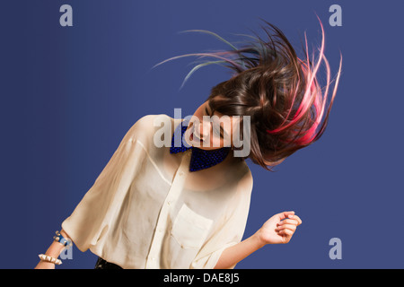 Portrait of young woman with dyed hair dancing Stock Photo