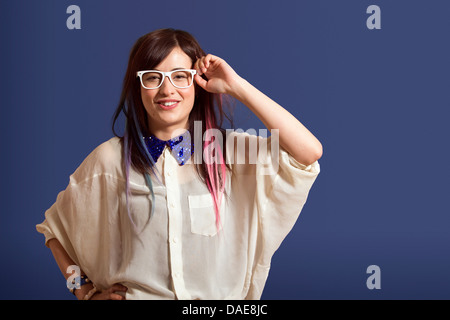 Portrait of young woman with dyed hair wearing glasses Stock Photo