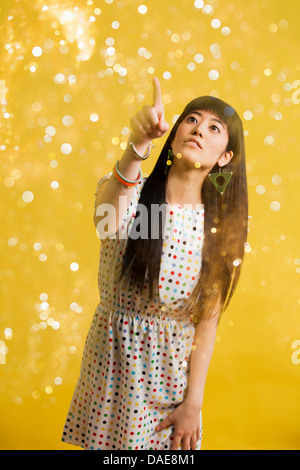 Portrait of young woman wearing spotted dress with glitter Stock Photo