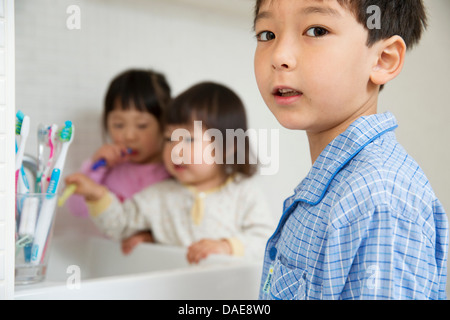 Portrait of young boy and sisters in bathroom Stock Photo