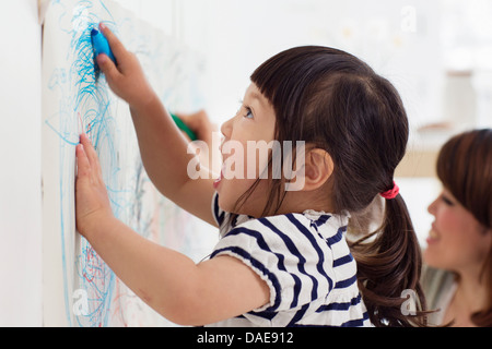 Close up portrait of female toddler having fun drawing Stock Photo