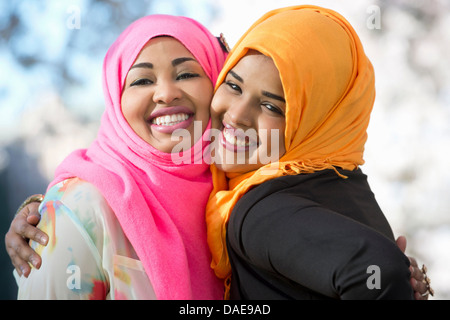 Close up portrait of two young woman in park Stock Photo