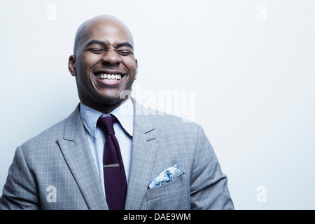 Studio portrait of businessman laughing Stock Photo