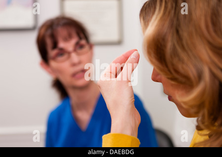 Patient explaining symptom to doctor in hospital Stock Photo