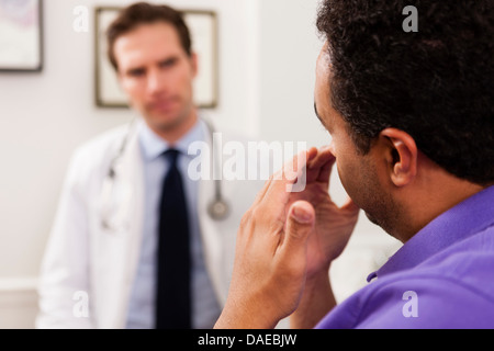 Mature patient explaining to doctor, close up Stock Photo