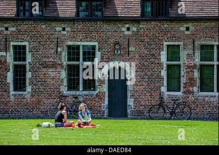 Female students in the Grand Béguinage / Great beguinage / Groot begijnhof at Leuven / Louvain, Belgium Stock Photo