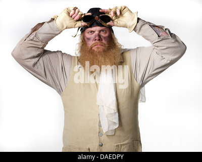 Old-Fashioned Male Aviato With Hands Touching Goggles, Portrait Stock Photo