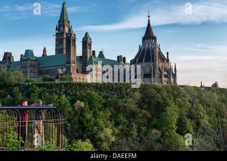 two kids enjoying the view of Parliament hill in Ottawa from Major's Hill Park Stock Photo