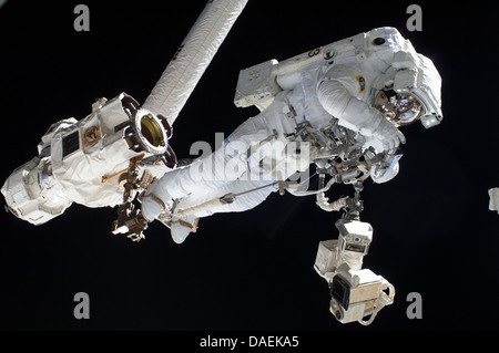 European Space Agency astronaut Luca Parmitano anchored to a Canadarm 2 mobile foot restraint during a spacewalk as work continues on the International Space Station July 9, 2013 in Earth orbit. During the six-hour, seven-minute spacewalk, Cassidy and Parmitano prepared the space station for a new Russian module and performed additional installations on the stations backbone. Stock Photo