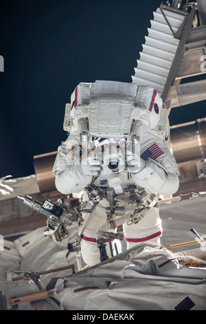 NASA astronaut Chris Cassidy takes a photograph during a spacewalk as work continues on the International Space Station July 9, 2013 in Earth orbit. During the six-hour, seven-minute spacewalk, Cassidy and Parmitano prepared the space station for a new Russian module and performed additional installations on the stations backbone. Stock Photo