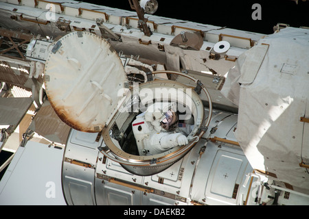 NASA astronaut Chris Cassidy emerges from the Quest airlock during a spacewalk as work continues on the International Space Station July 9, 2013 in Earth orbit. During the six-hour, seven-minute spacewalk, Cassidy and Parmitano prepared the space station for a new Russian module and performed additional installations on the stations backbone. Stock Photo