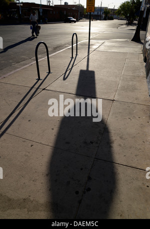 An early morning riser heads down North Fourth Avenue to beat a summer's day heat on June 8, 2013, Tucson, Arizona, USA. Stock Photo