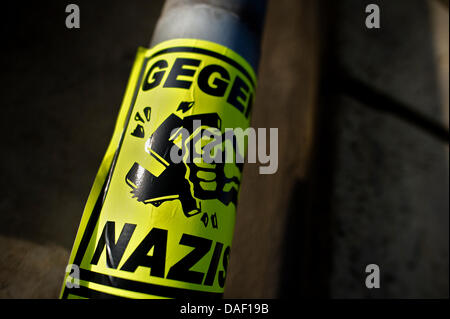 A yellow sticker, which reads 'Against Nazis', is attached to a traffic sign in Dresden, Germany, 24 November 2011. A sepcial unit of the GSG9, a counter-terrorism and special operations unit of the German Federal Police, arrested an alleged neo-nazi terrorist in Brandenburg this Thursday, 24 November 2011. Officers of the German Federal Police searched the apartment of the suspect Stock Photo