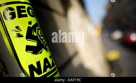 A yellow sticker, which reads 'Against Nazis', is attached to a traffic sign in Dresden, Germany, 24 November 2011. A sepcial unit of the GSG9, a counter-terrorism and special operations unit of the German Federal Police, arrested an alleged neo-nazi terrorist in Brandenburg this Thursday, 24 November 2011. Officers of the German Federal Police searched the apartment of the suspect Stock Photo