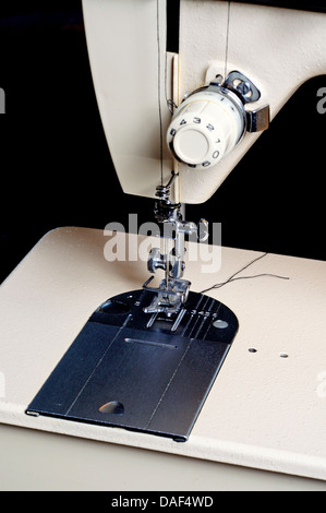 Sewing machine foot plate and needle. Stock Photo
