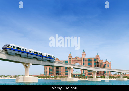 Monorail train approaching The Palm Atlantis luxury hotel on artificial Palm Jumeirah island in Dubai United Arab Emirates Stock Photo