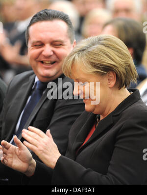 German Chancellor Angela Merkel and the Prime Minister of Baden-Wuertemberg, Stefan Mappus, laugh together during a Christian Democrats election campaign event in Gammertingen, Germany, 14 February 2011. State elections in Baden-Wuerttemberg will be held on 27 March 2011. Photo: Patrick Seeger Stock Photo