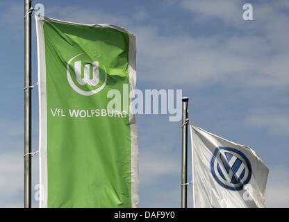 A file picture dated 23 June 2008 shows flags of VW and the Bundesliga club Wolfsburg in Wolfsburg, Germany. According to information by the German daily 'Sueddeutschte Zeitung', the Public Prosecution Service Stuttgart is currently investigating against employees of VW and Telekom. They are suspected to have attemted to make a sum of several million Euro by prolonging advertisemen Stock Photo